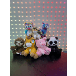 Assorted plush animals arranged on a table in front of string lights.