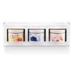 Set of three floral patterned tin candles in a white rectangular gift box