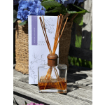 Reed diffuser in a glass bottle with a lavender-themed box