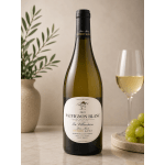 Bottle of white wine beside a glass and grapes