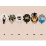 Six graduation balloons with Spanish congratulatory text on sticks