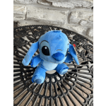 Blue plush Stitch toy sitting on a black metal table