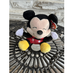 Mickey Mouse plush toy sitting on a metal table