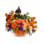 Orange floral arrangement in a pumpkin container with a haunted house pick