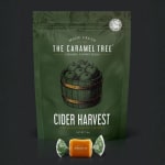 Green bag of caramel candies with one wrapped caramel in front