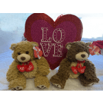Two teddy bears with a glittery heart sign reading LOVE