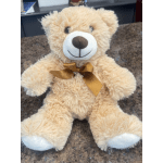 Plush teddy bear with a gold ribbon bow