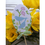 Yellow daffodils with a glittery Easter egg pick