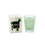 Green scented candle in a glass tumbler beside its box
