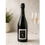 Bottle of brut champagne beside two filled flutes
