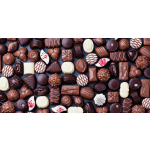Assorted chocolates arranged in rows on a dark surface