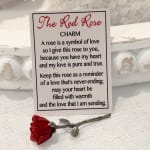 A small red rose charm with a printed love poem card.