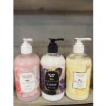 Three pump bottles of body care products on a shelf