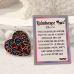 Heart-shaped colorful charm beside a printed message card