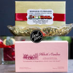 Two boxed candy gifts with branded labels and ribbon