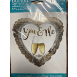 Heart-shaped balloon with "You & Me" and two champagne flutes