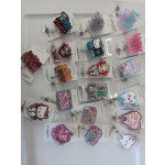 Assorted glittery badge reels with cartoon and text designs