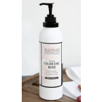 White pump bottle of charcoal rose lotion on a wooden surface