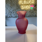 Pink frosted glass vase on a table