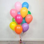 Cluster of colorful balloons tied together indoors