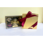 Two boxes of chocolate truffles, one tied with a burgundy ribbon.