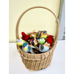 Wicker basket filled with colorful decorative bird figurines