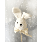 White plush bunny head pick with long ears and cream bow on a stick