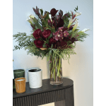 Deep burgundy bouquet with white calla lilies in a clear glass vase