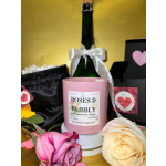 Pink candle with roses and bubbly label, surrounded by roses and gift boxes