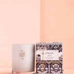 White candle beside a patterned Lollia Dream box