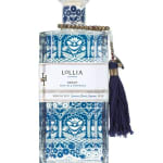 Decorative blue-and-white perfume bottle with a tassel charm