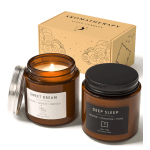 Two amber jar candles with a matching box, one lit