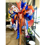 Decorative ribbon bow in blue, orange, and white with basketball patterns