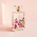Floral perfume bottle with pink and yellow flower artwork