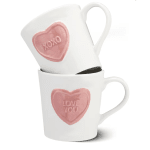 Two white mugs with pink heart candy designs stacked together