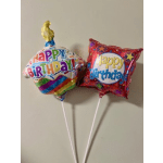 Two birthday foil balloons on sticks, one round and one square-shaped
