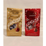 Two Lindt Lindor chocolate gift bags, one gold and one red