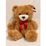 Brown teddy bear with a red ribbon bow