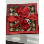 Box of gold-wrapped chocolates tied with a red ribbon
