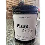 Black jar candle labeled Plum & Ivy