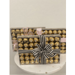 Boxes of gold-wrapped chocolates tied with ribbon