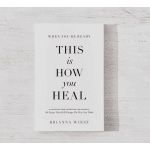 White self-help book titled 'This Is How You Heal' on a light wooden surface