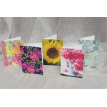 Five floral greeting cards displayed in a row, including a sunflower card and pink flower designs.
