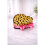 Heart-shaped arrangement of gold-wrapped chocolates with a pink ribbon bow