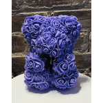 Purple rose-shaped teddy bear on a white surface