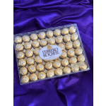 Box of Ferrero Rocher chocolates on purple satin fabric