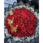 Round bouquet of red roses with white baby's breath and gold butterfly accents