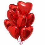 Cluster of red heart-shaped balloons on white background