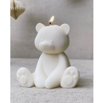 White bear-shaped candle with a small flame