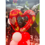 Red heart-shaped balloons with smaller red and white balloons below